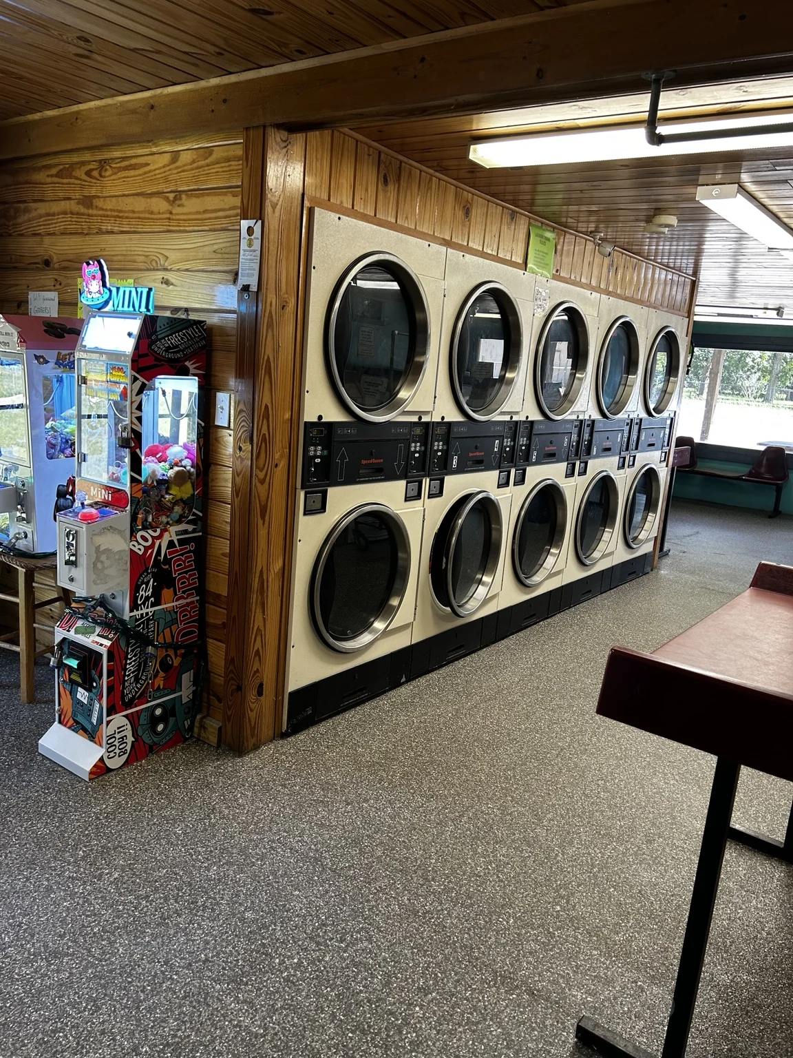 Stacked dryers along the wood-paneled wall