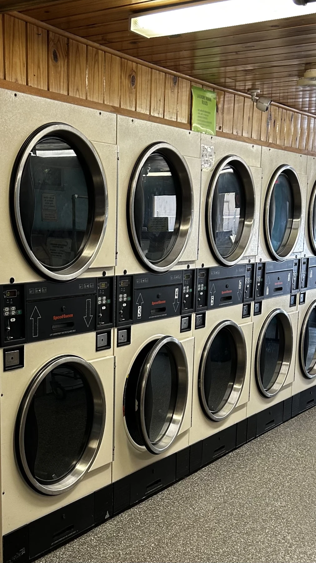Rows of Speed Queen dryers beneath Goobers wood-paneled walls and ceiling