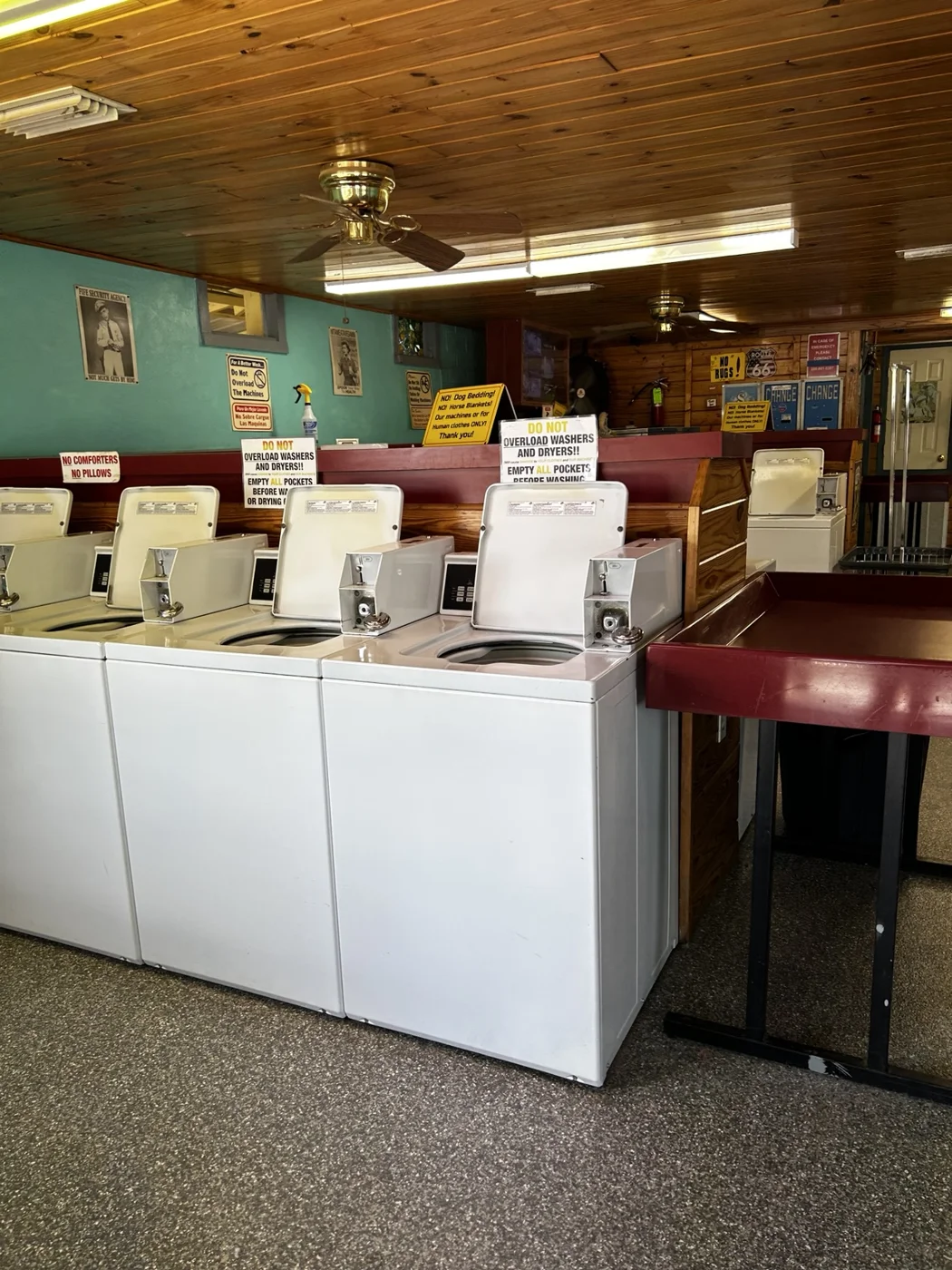 Top-loading washers under Goobers wood-paneled ceiling