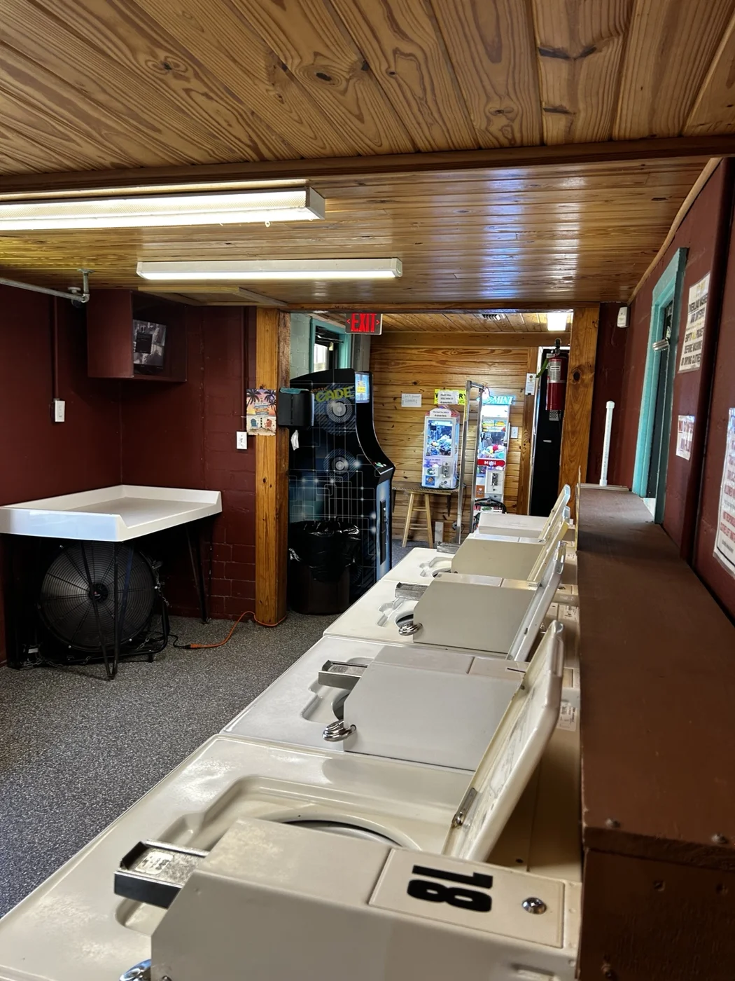 The wood-paneled laundry room with washers and folding spaces